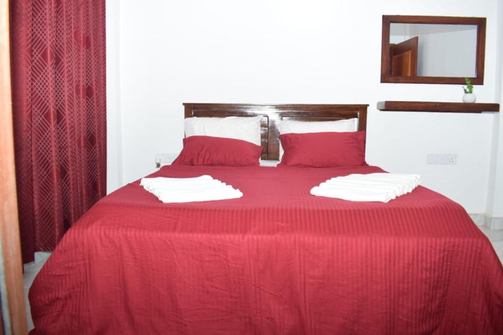 Postel nebo postele na pokoji v ubytování The Alexis's Guest House