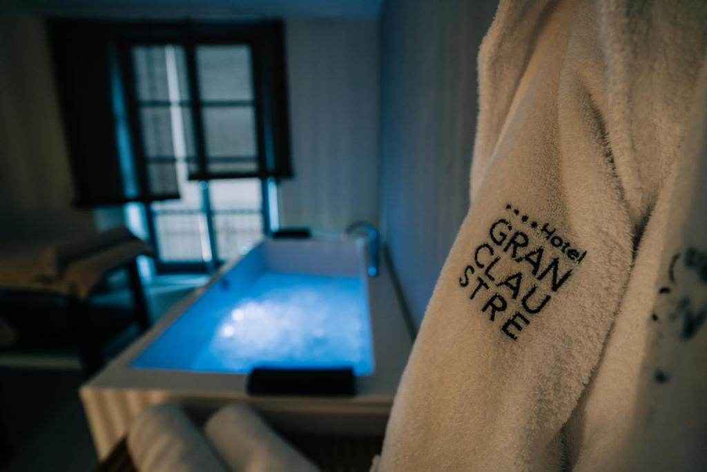 a person with a tattoo on their arm next to a table at Gran Claustre Boutique Hotel in Altafulla