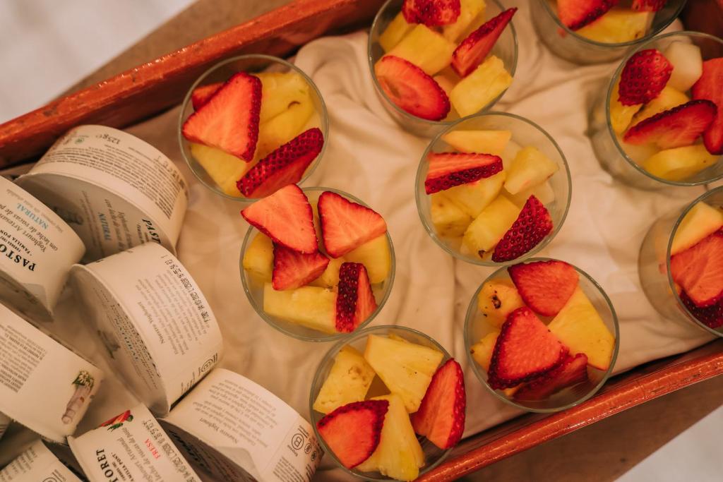 a display of fruit in glass bowls with books at Gran Claustre Boutique Hotel in Altafulla