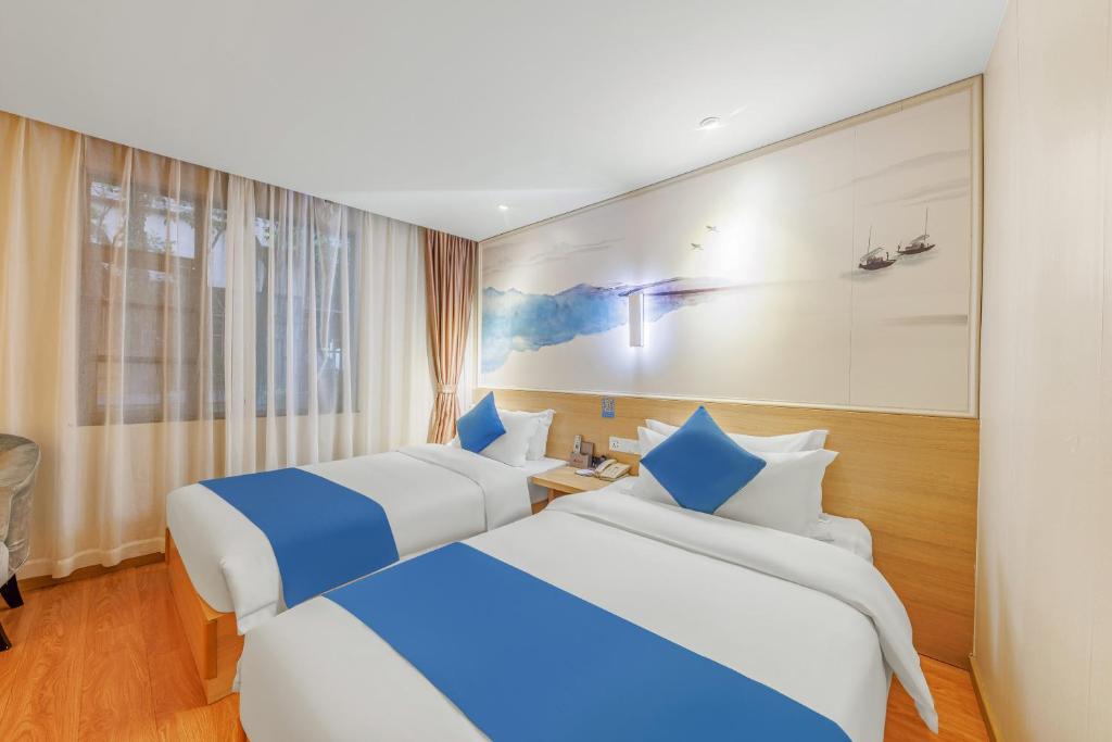 Postel nebo postele na pokoji v ubytování Guangzhou Hongcheng Hotel