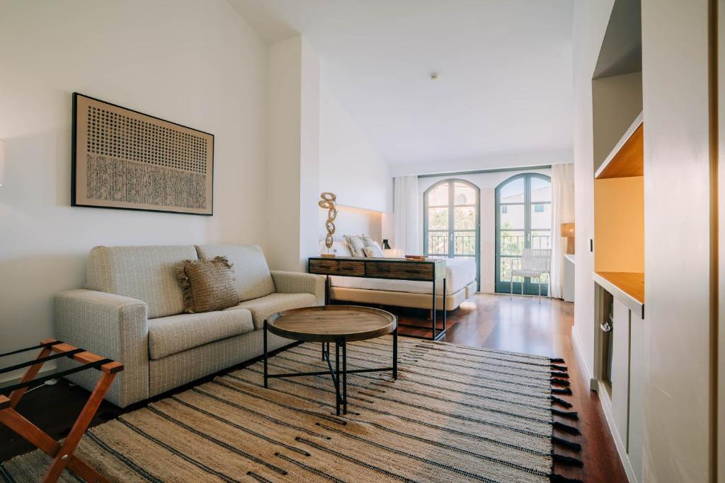 a living room with a couch and a table at Gran Claustre Boutique Hotel in Altafulla