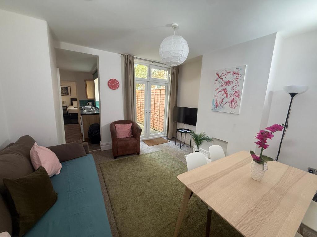 a living room with a couch and a table at Central 2 bed flat with off street-parking in Bristol