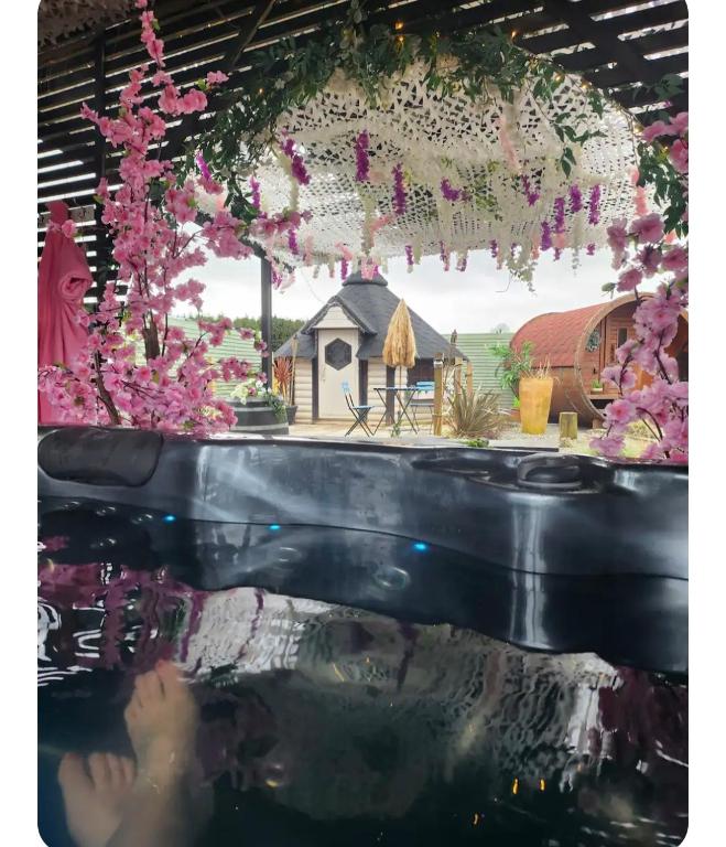a woman in a bathtub with a house in the background at Adult only , meadow escape in Coagh