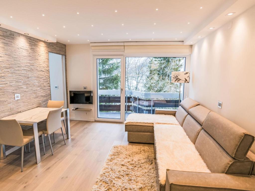 a living room with a couch and a table at Apartment Flaminia 39 by Interhome in Leukerbad