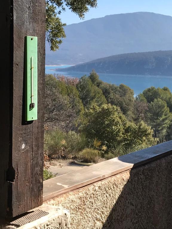 a switch on a wall with a view of a road at appartement confortable in Sainte-Croix-de-Verdon