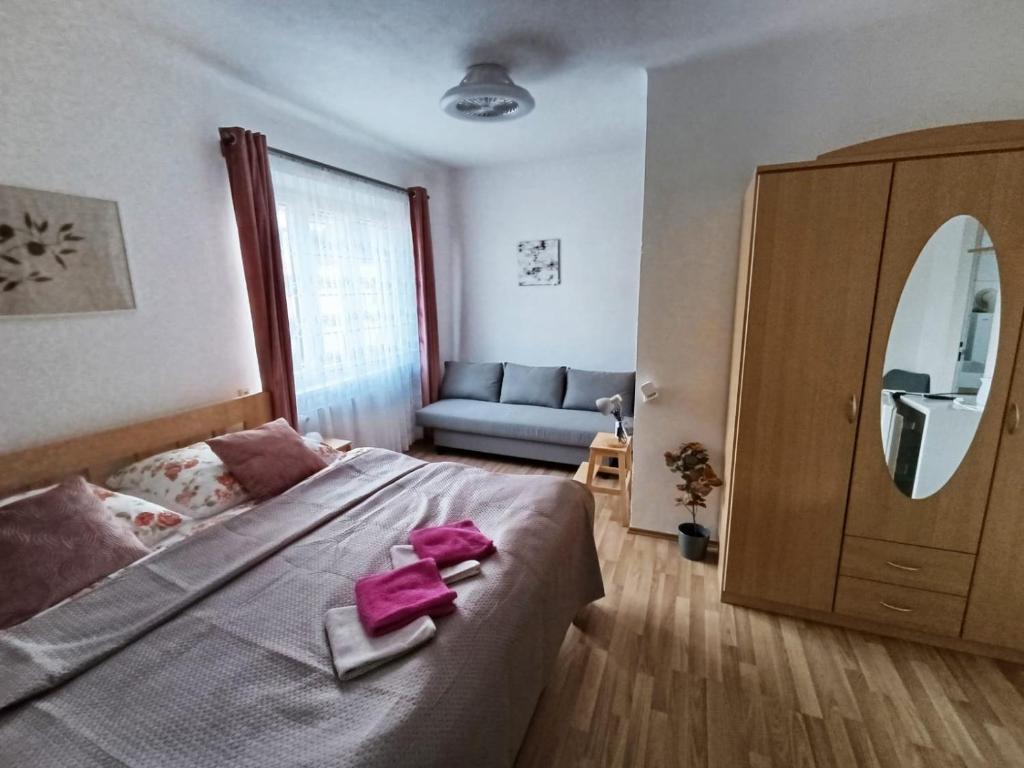 a bedroom with a large bed with a pink bow on it at Ubytování Pohoda in Třeboň