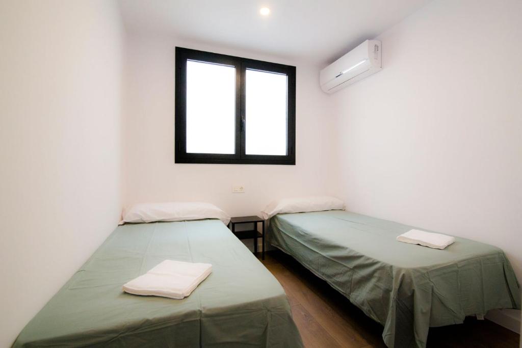 Posteľ alebo postele v izbe v ubytovaní REUSIA Apartaments