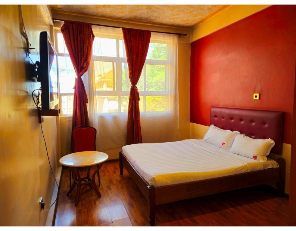 Postel nebo postele na pokoji v ubytování Pearl Palace Hotel