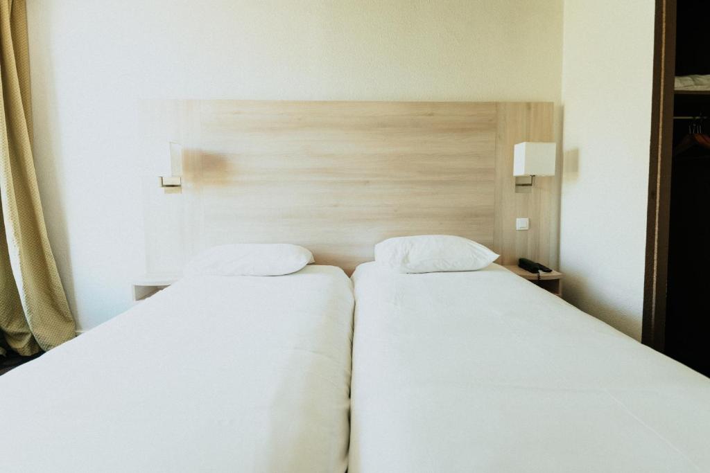 Postel nebo postele na pokoji v ubytování Hôtel d'Orsay