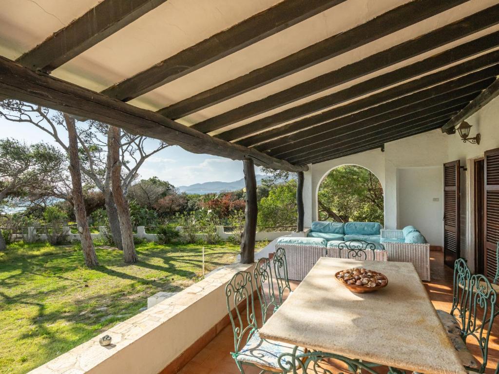 a patio with a table and chairs on a porch at Villa La Conchiglia by Interhome in Villasimius