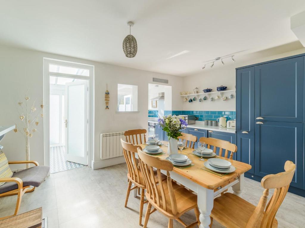 a kitchen and dining room with a wooden table and chairs at Holiday Home Lighthouse Watch by Interhome in Mevagissey