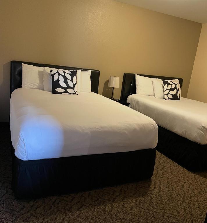 a hotel room with two beds with white sheets at Williamsport Grandview Hotel in Linden