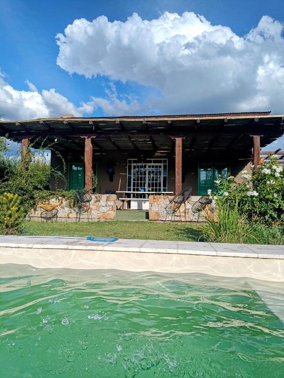 a swimming pool in front of a house at El rancho de Ana in Colonia Las Rosas