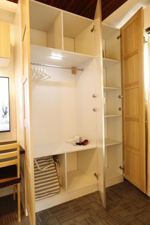a walk in closet with white shelves at La Joya Suite in Naga
