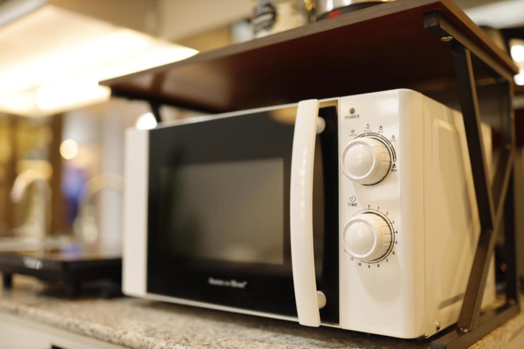 a microwave sitting on top of a counter at La Joya Suite in Naga