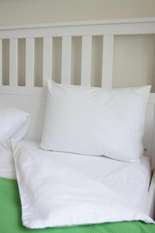 a white bed with four pillows on top of it at Petrocelli apartment in La Romanina