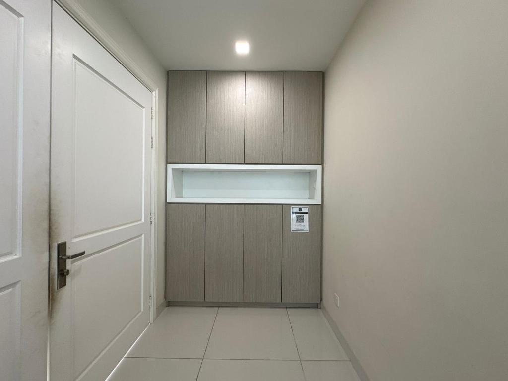 a hallway with a wooden cabinet and a door at Luxury 5BR stay walk to beach & Night market fun in Batu Ferringhi