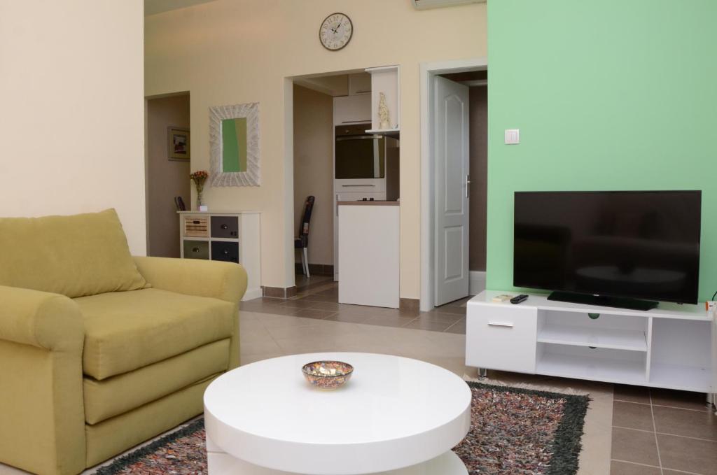 a living room with a couch and a tv at Apartment Katarina in Banja Koviljača