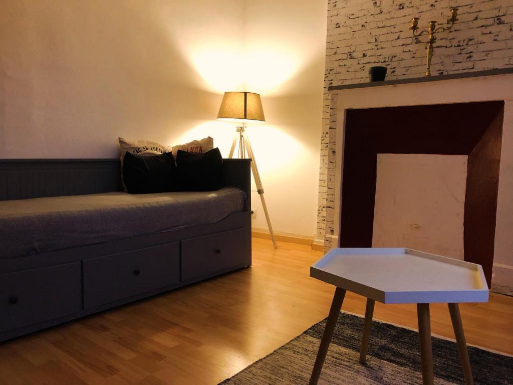 a living room with a couch and a table at Appartement Les Bons Vivants au coeur de Perrigny in Perrigny-sur-Loire