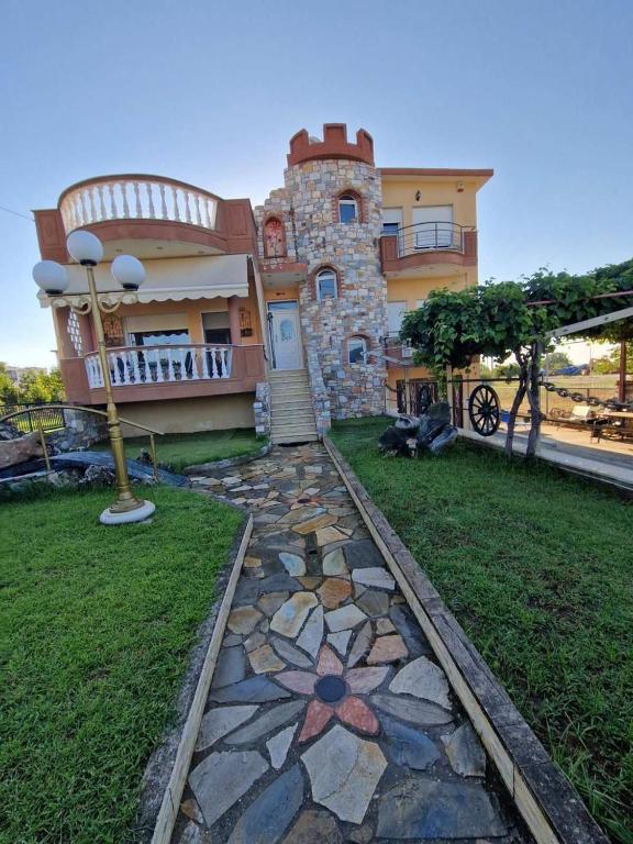 a house with a stone walkway in front of it at Sweet Dreams Villa in Pondolívadhon