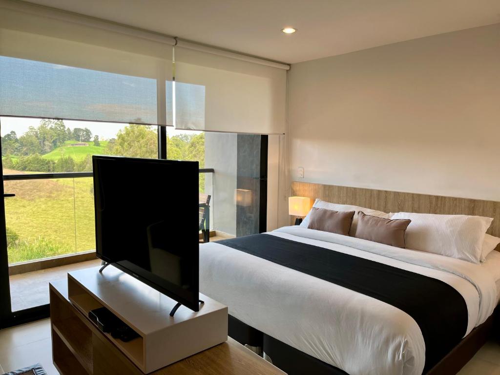 Postel nebo postele na pokoji v ubytování Suites - Hotel Rioverde