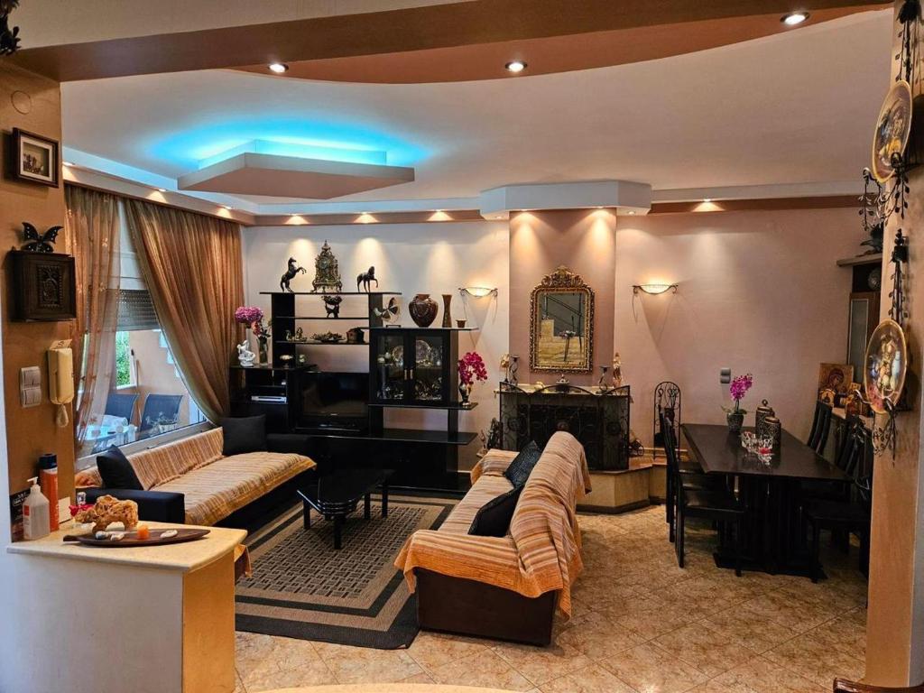 a living room with a couch and a table at Sweet Dreams Villa in Pondolívadhon