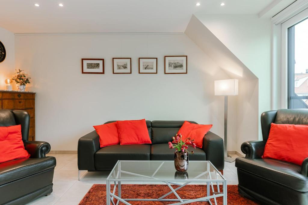 a living room with two couches and a coffee table at Huswell - Home feeling apartment on top location in Knokke in Knokke-Heist