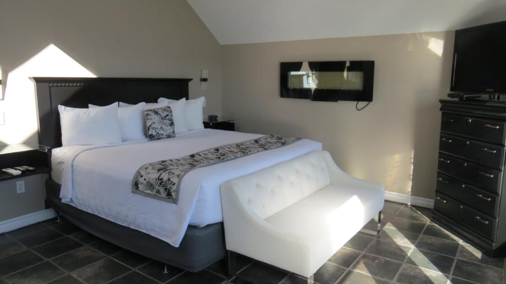 a hotel room with a bed and a chair at Dockside Suites in Digby