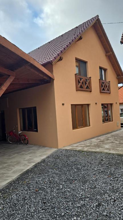 a house with a bike parked in front of it at Pensiunea Deak Panzio in Sovata