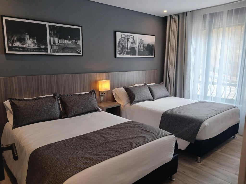 Postel nebo postele na pokoji v ubytování Hotel Santino