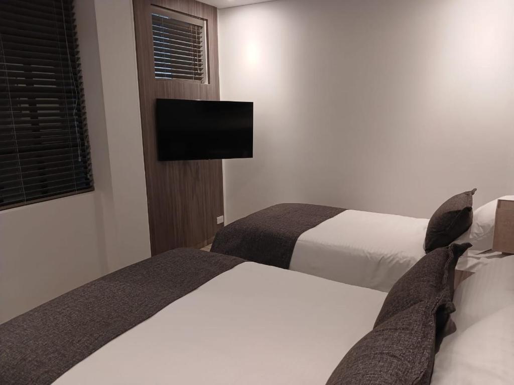 Postel nebo postele na pokoji v ubytování Hotel Santino