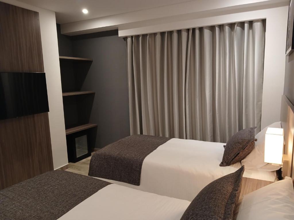 Postel nebo postele na pokoji v ubytování Hotel Santino