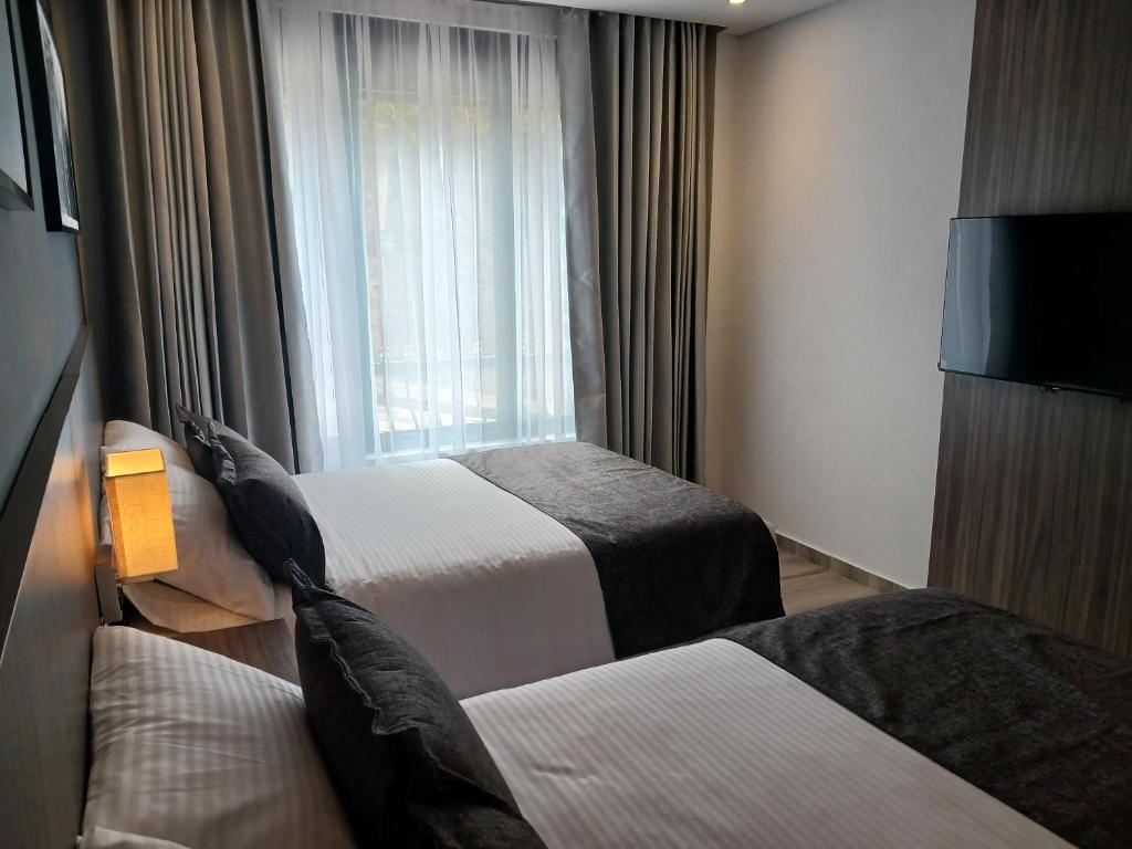 Postel nebo postele na pokoji v ubytování Hotel Santino