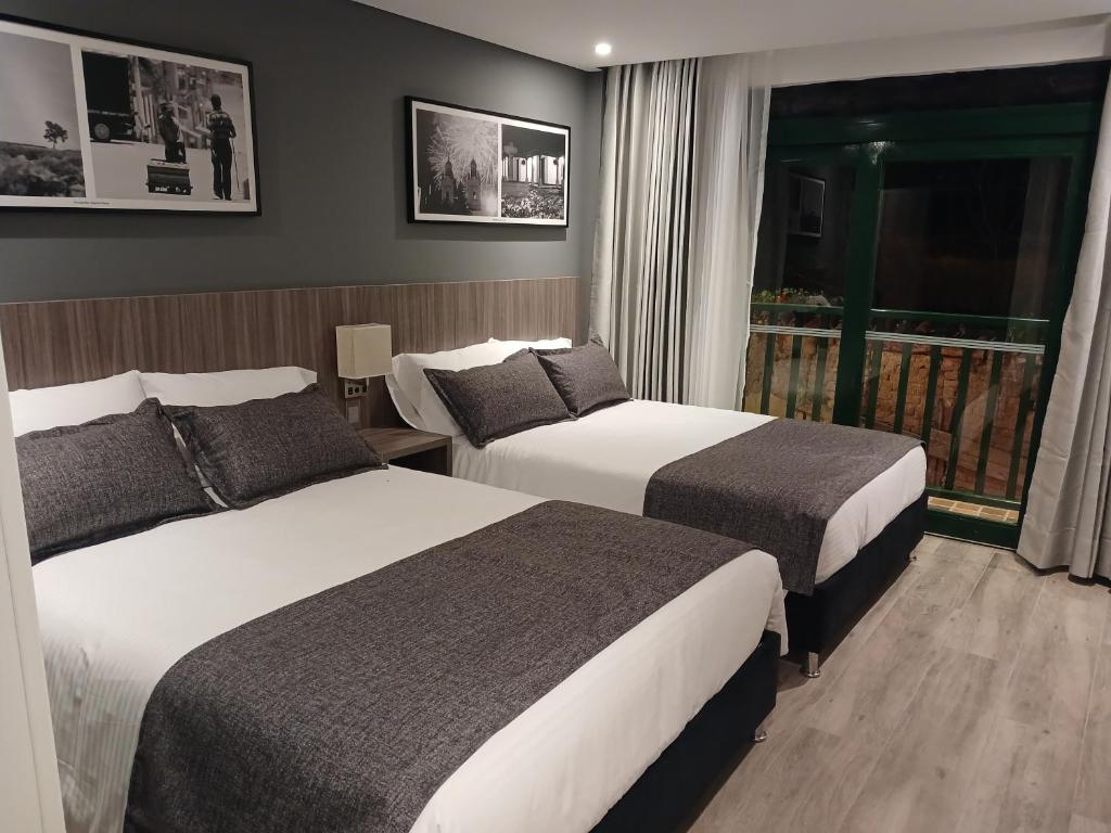 Postel nebo postele na pokoji v ubytování Hotel Santino