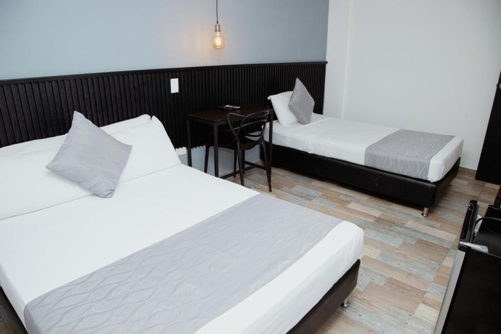 Postel nebo postele na pokoji v ubytování Hotel Palmas del Estadio