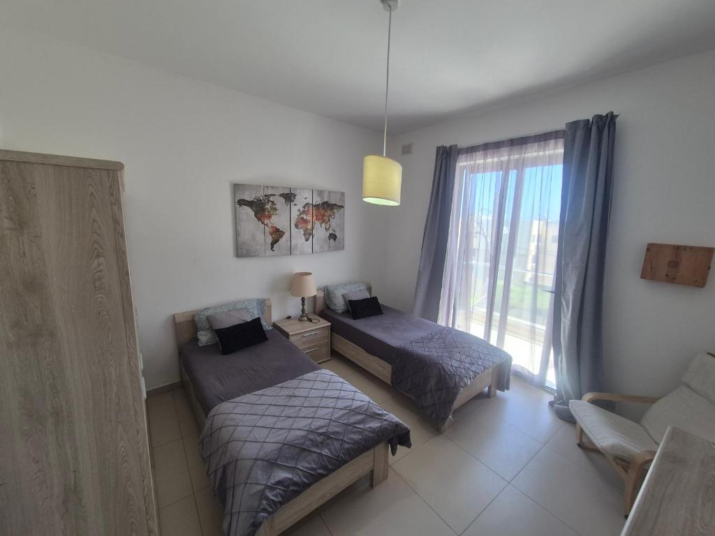 Postel nebo postele na pokoji v ubytování ICC Holiday apartment in Marsascala