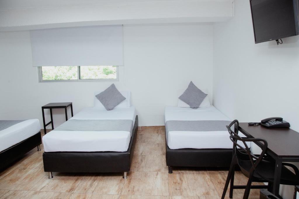 Postel nebo postele na pokoji v ubytování Hotel Palmas del Estadio
