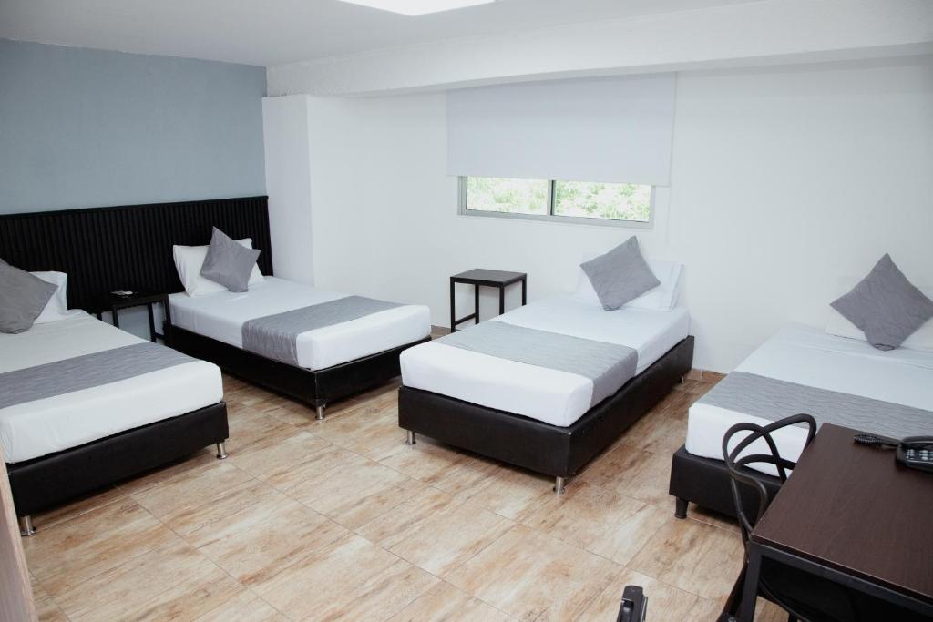 Postel nebo postele na pokoji v ubytování Hotel Palmas del Estadio