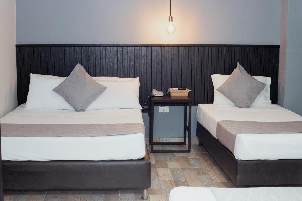 Postel nebo postele na pokoji v ubytování Hotel Palmas del Estadio