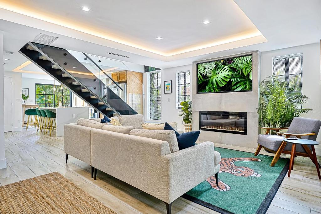 a living room with a couch and a fireplace at Villa Verde Miami in Miami