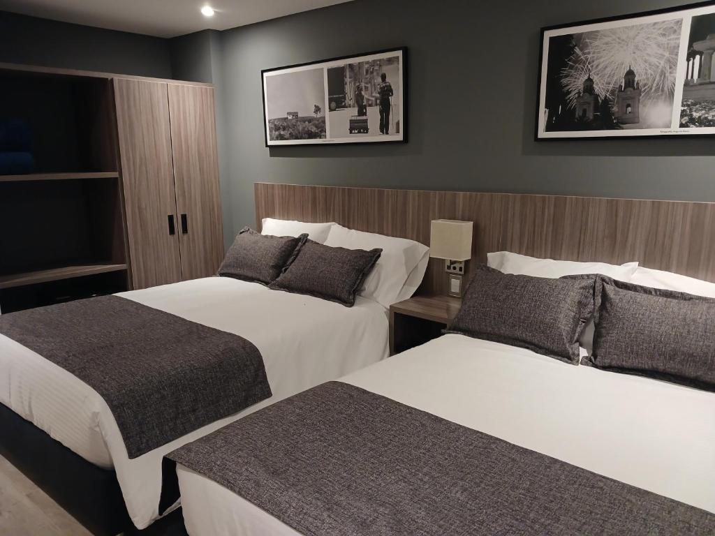 Postel nebo postele na pokoji v ubytování Hotel Santino
