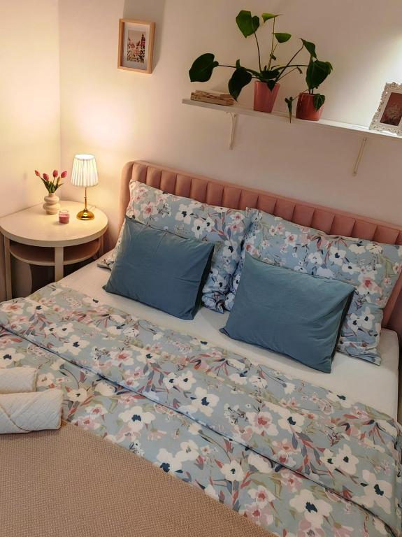 a bedroom with a bed with blue pillows at Etela Old Town Apartment in Košice