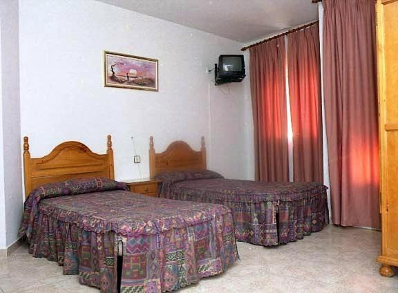 Postel nebo postele na pokoji v ubytování Hotel Limas