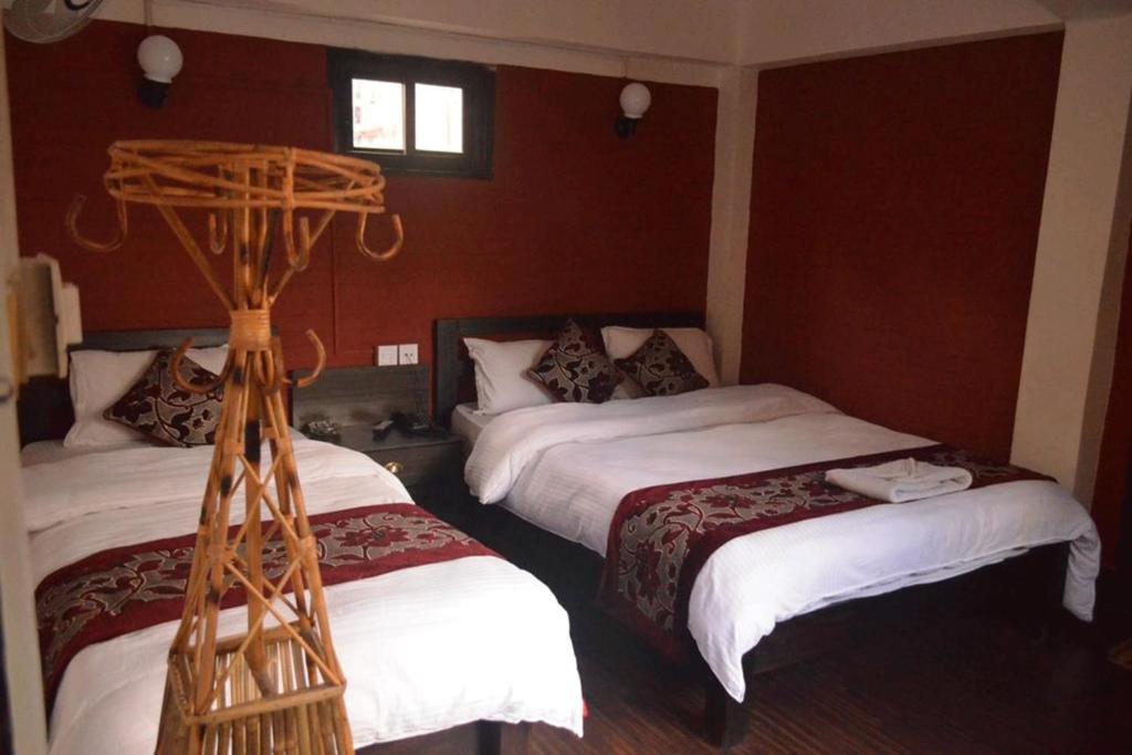 Postel nebo postele na pokoji v ubytování Red Tiger Resort
