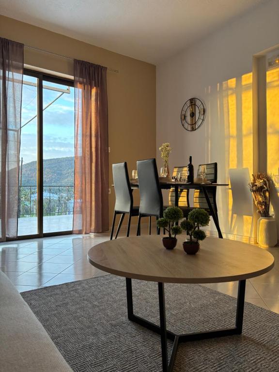 a living room with a table and chairs at V&G Cozy Home near Lindos, Spacious 2BR in vlicha