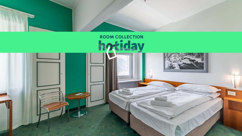 Postel nebo postele na pokoji v ubytování HOTIDAY Room Collection - Sauze Torre