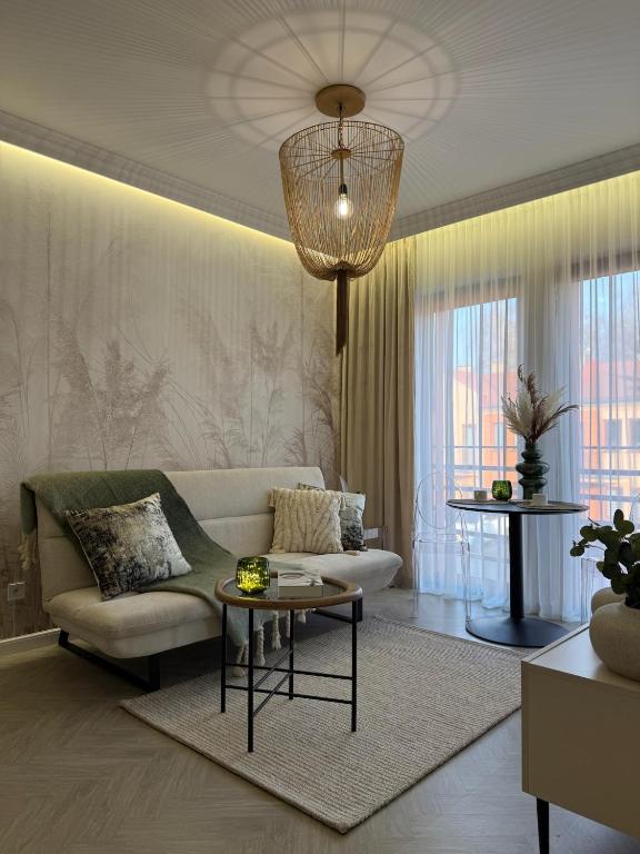 a living room with a couch and a table at Apartament Pod Żaglami 4 in Sława