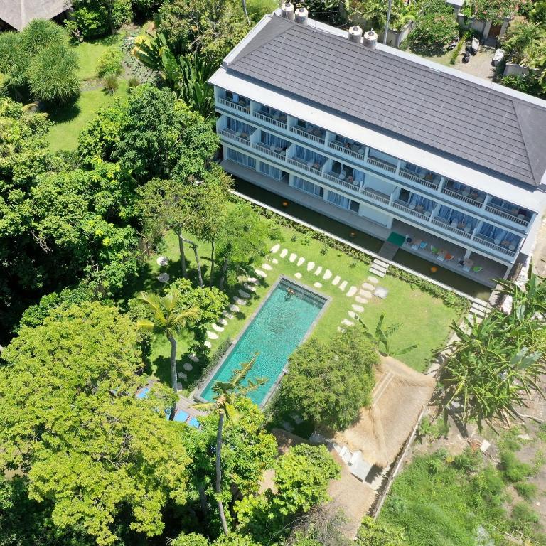 an aerial view of a building with a swimming pool at Mahamustika Riverside in Canggu