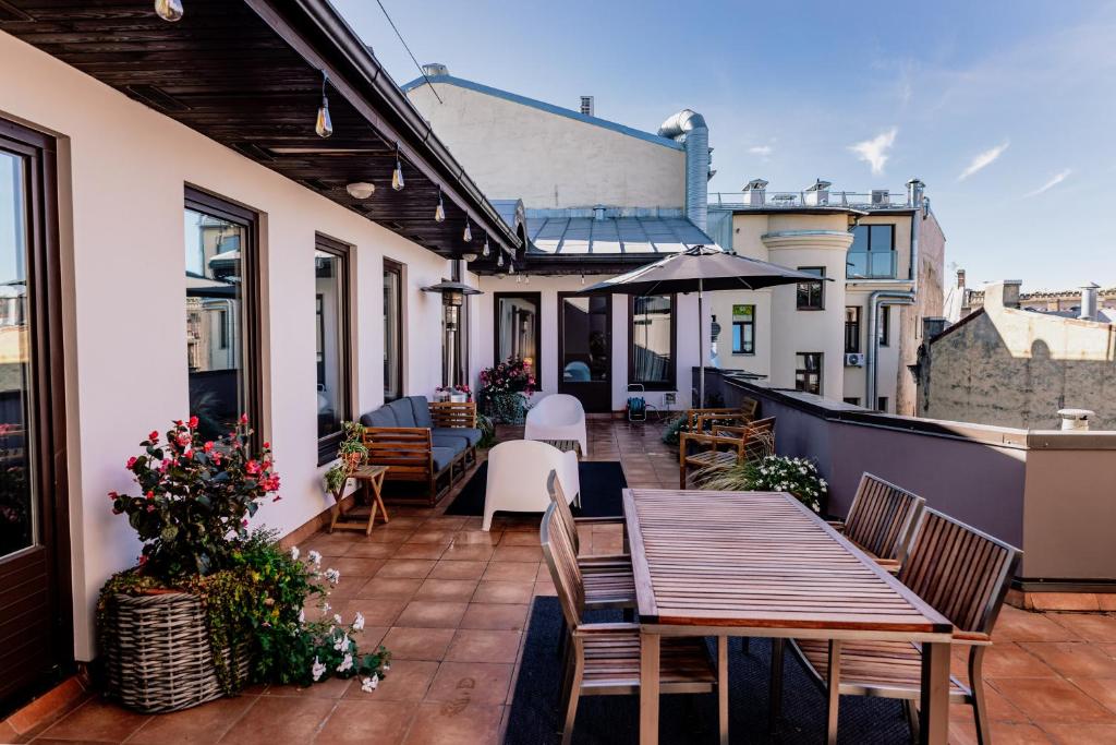 a patio with a table and chairs on a balcony at Spacious 2-story apt. w/ terrace - 280 m2 in Riga