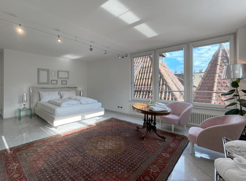 a bedroom with a bed and a table and a window at Artist House in Merano